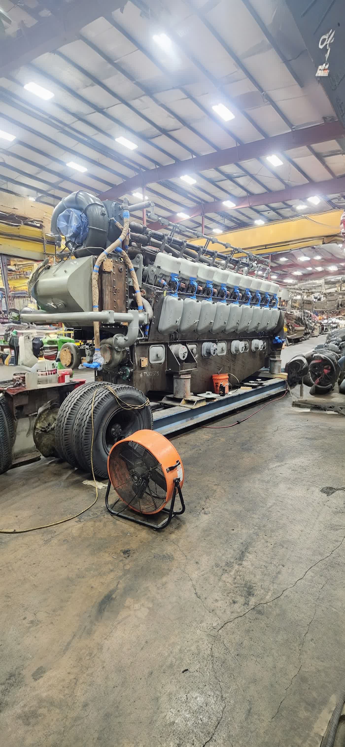 V16 engine block staged on its transport frame for coating work