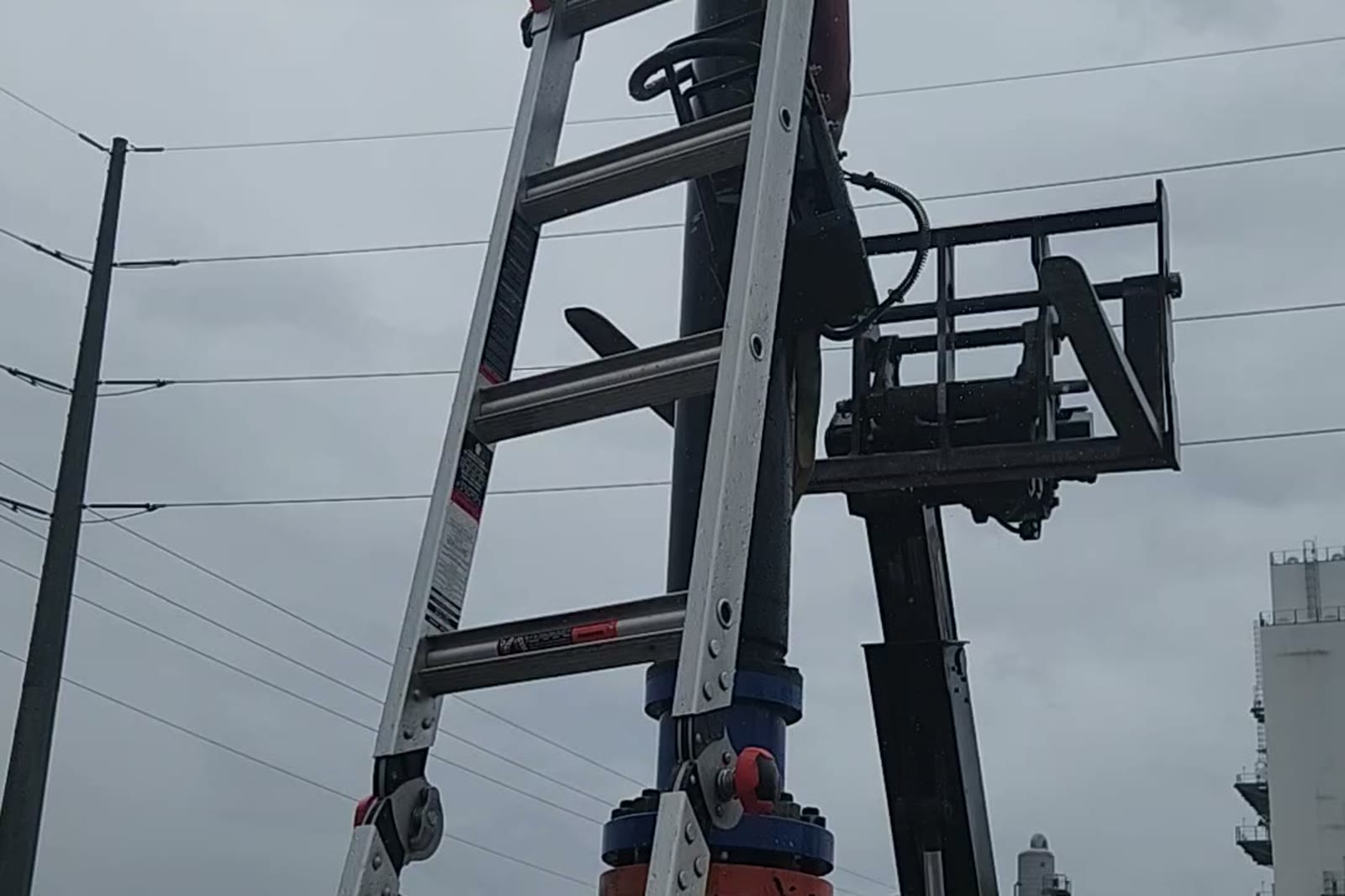 Tapping machine rigged vertically on the live 8 in. natural gas line during the cut