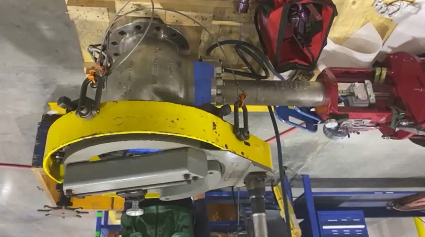 Portable flange facing machine mounted and rigged to the 8 in. Class 600 cryogenic PSV, valve blocked and cribbed for the resurfacing pass