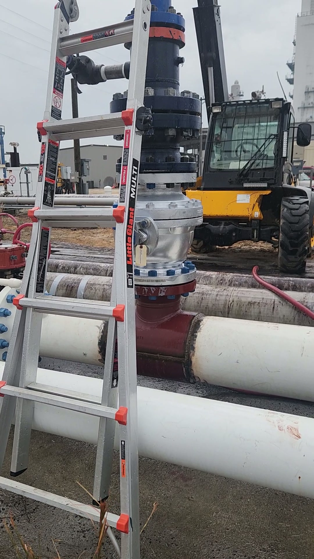 Tapping machine rigged vertically on the live 8 in. natural gas line during the cut