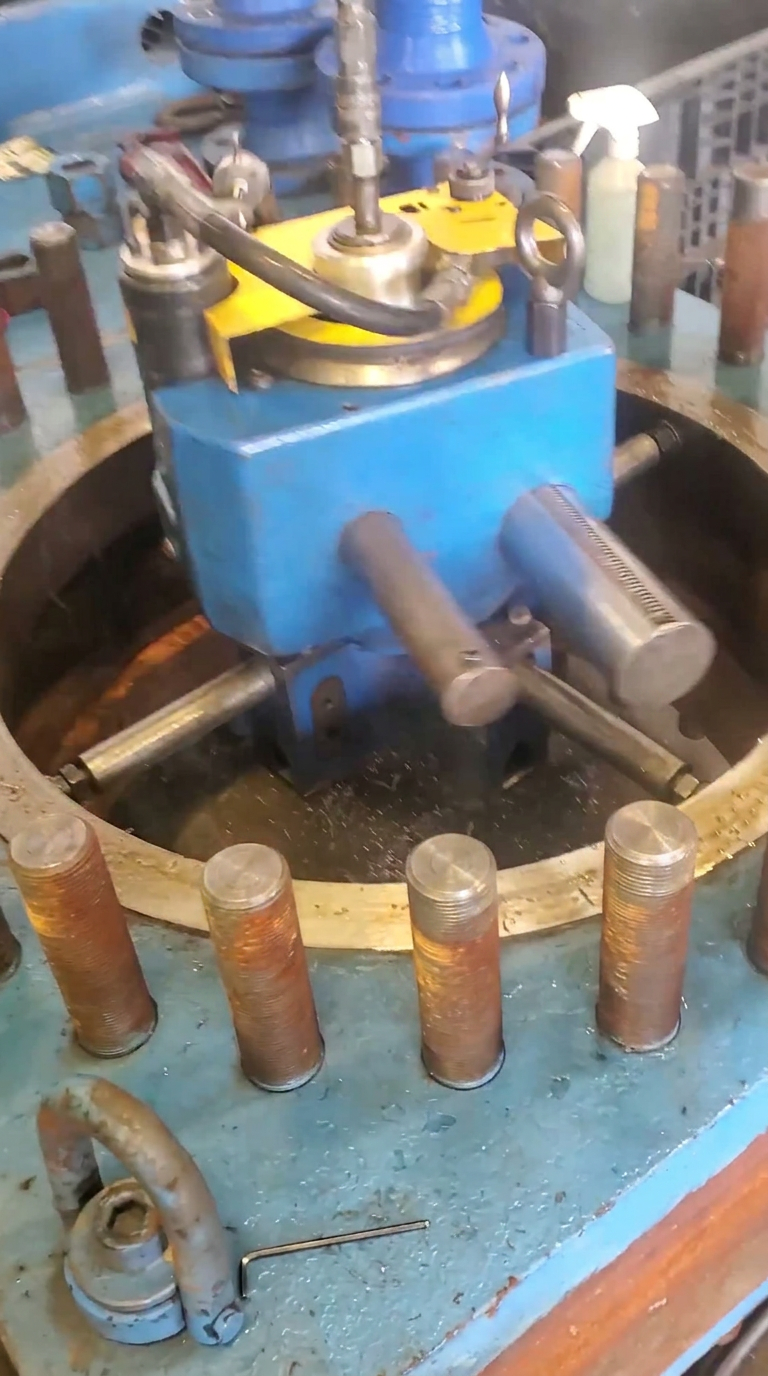 Machining unit cutting the sandwich-valve sealing area inside the fixture, studs and gasket area masked from chips