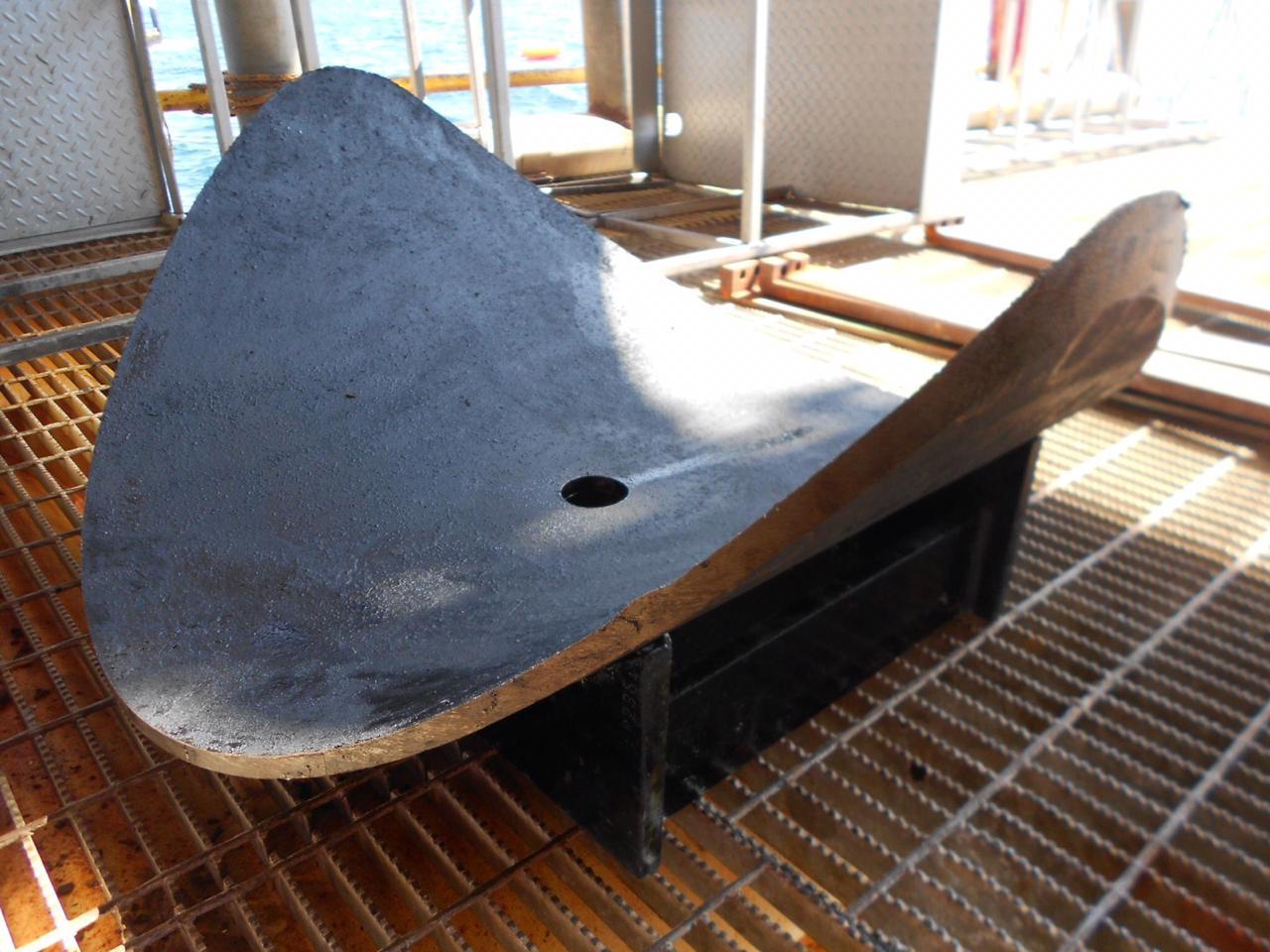 Rolled plate coupon recovered from the 36 in. pipe wall — full-diameter cut as removed
