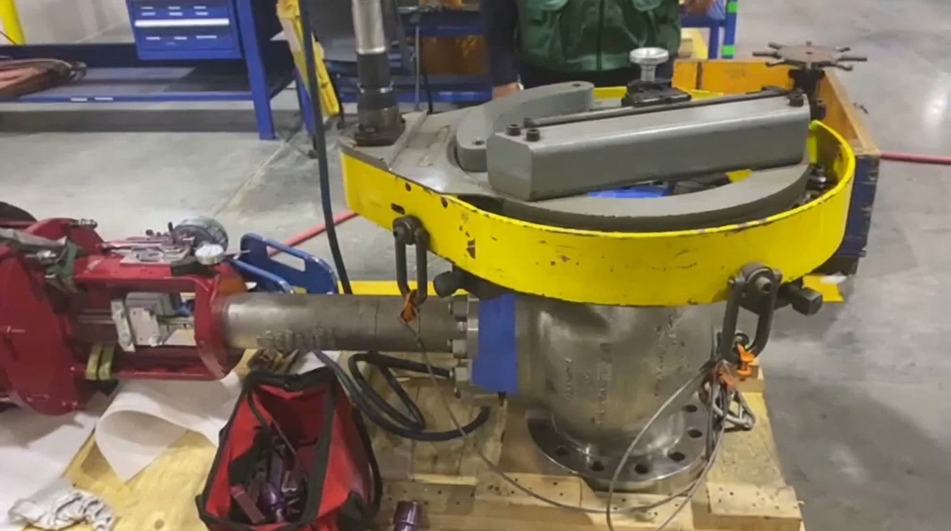 Portable flange facing machine mounted and rigged to the 8 in. Class 600 cryogenic PSV, valve blocked and cribbed for the resurfacing pass